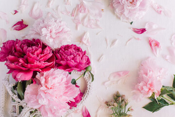 Stylish floral composition made of peonies with space for text on white background. Flat lay, top view blog hero header.