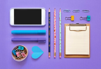 School flatlay voilet background. School supplies. Notebook, markers, 
paper clips, pen, clamp, phone. School banner 2020. Back to school. Top view. 