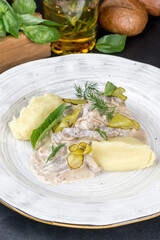 Beef stroganoff with meat, potatoes, fresh herbs