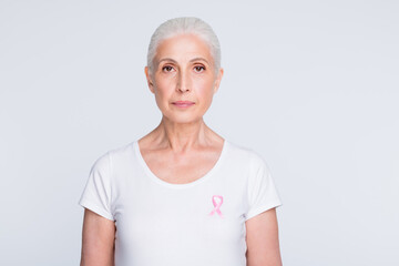 Portrait of confident person having pink ribbon wearing stylish t-shirt isolated over white...