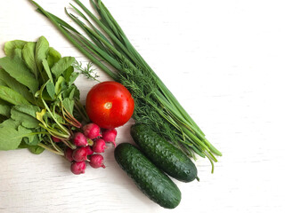 Fresh and juicy vegetables are placed in a white wooden background, top view