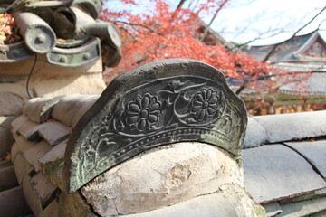 Close-up of traditional Korean ceramic roof tile with flower image on Bulguksa Temple, Gyeong-ju, South Korea
