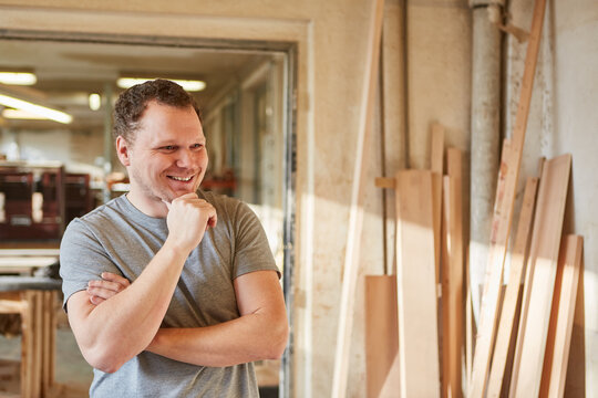 Young man as a satisfied carpenter apprentice