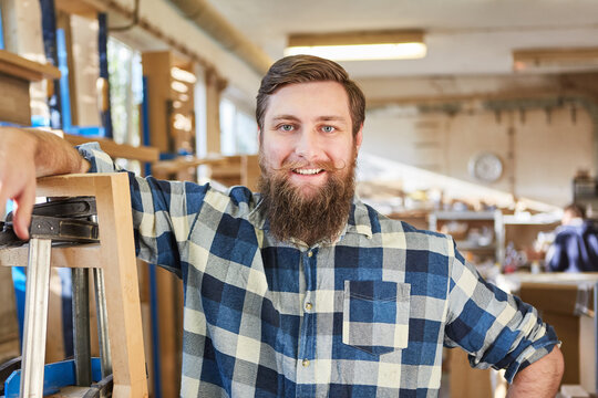 Hipster man with a beard as a satisfied artisan