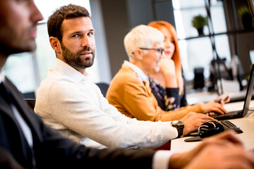 Young professional businessman uses a computer for work in the office