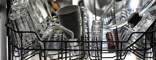 dishes in an open dishwasher, home style lifestyle, cleanliness and convenience background
