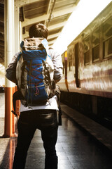 Traveler with backpack in train station vintage tone. travel concept.