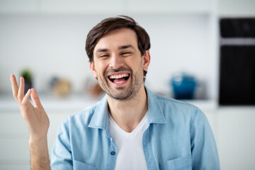 Closeup photo of young cheerful friendly guy internet online meeting video call lesson conference good mood webcam talk laughing out loud excited glad social distance quarantine indoors