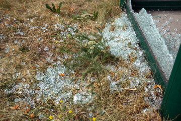 broken glass at a train station platform shelter