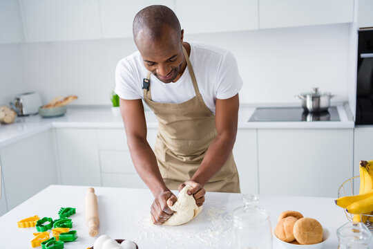 Portrait of nice attractive guy making fresh bread pie pide doughing flour learning practicing courses lesson classes workshop spending free time in modern light white interior house kitchen