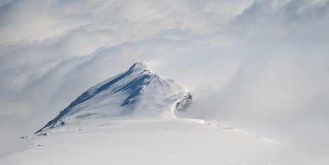 Spring alp scenery from Molltal glacier. Rocks, clouds and sun over ski slopes. Austria, Carinthia, April 2016