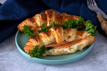 Butter croissants with cream cheese and lox. Tasty breakfast. Close up
