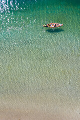 top view to kayak boat on plansee lake water with wave reflections