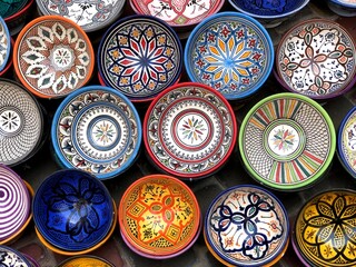 Colorful ceramics and pottery displayed outside in the market.