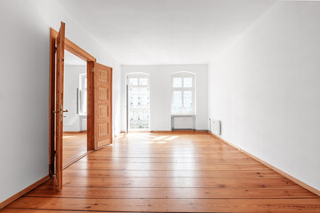 empty room in renovated  flat  with wooden  floor and balcony