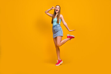 Fototapeta na wymiar Full length body size view of her she nice attractive cheerful cheery overjoyed straight-haired girl having fun showing v-sign isolated over bright vivid shine vibrant yellow color background