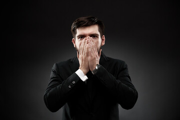 Man gesture showing stress and fright, covering face