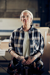 Tattooed female craftsman with tools