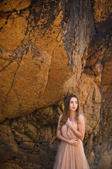 lifestyle photo of woman with perfect hair.walking alone at the beach.Sensual young girl relaxing.Colorful filter.glam style,teen trend outfit, positive mood,smiling,amazing model girl,long hair