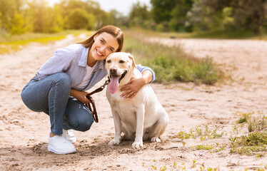 Excited woman and golden retriever walking outdoors