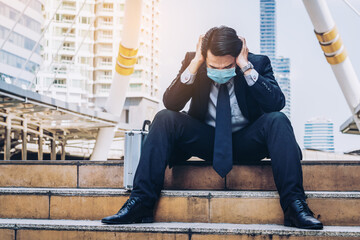 Unhappy sad business man with face mask protect from Coronavirus or Covid-19. Concept of...