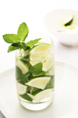 Lime wedges and mint leaves