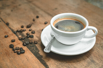 black coffee latte with coffee bean on wood table