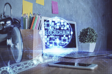 Double exposure of blockchain and crypto economy theme hologram and table with computer background. Concept of bitcoin cryptocurrency.