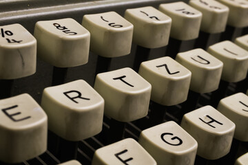 Macro closeup of isolated keys of old typewriter with letters and symbols, black background