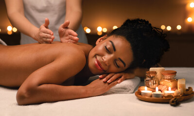 Obraz na płótnie Canvas Black woman getting classic body massage at spa