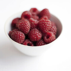 Close up of some raspberries in a bowl