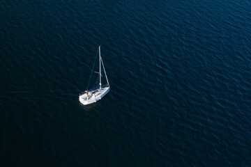 lonely white sailing yacht at sea, aerial view