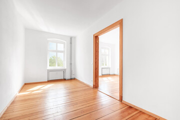 empty room in renovated apartment flat  with wooden boardfloor and white walls