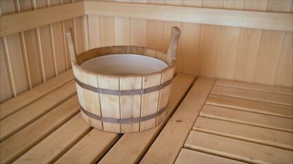 Interior details Finnish sauna steam room with traditional sauna accessories basin scoop. Traditional old Russian bathhouse SPA Concept.