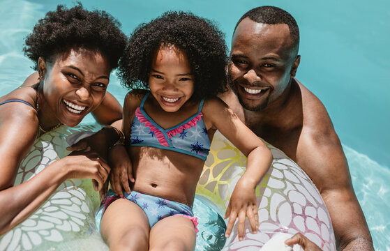 Family in pool in a summer day