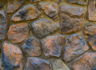 Fragment of a wall of charred brown stones
