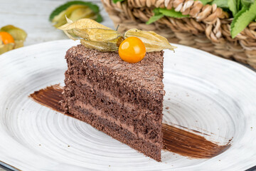 Slice of Prague cake on a white, round plate