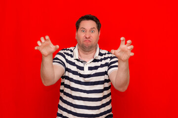 Gesturing american man wearing casual striped t-shirt funny doing claw gesture as cat