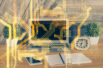Computer on desktop in office with technology theme hologram. Multi exposure. Tech concept.