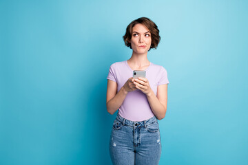 Photo of unsure minded addicted social network blogger girl use cellphone look copyspace use...