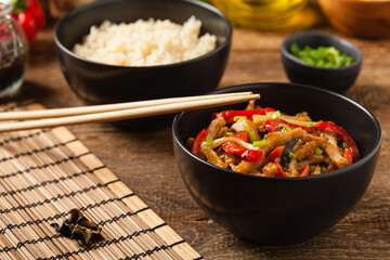 Pork chop with peppers, mushrooms and bamboo. Served with rice.