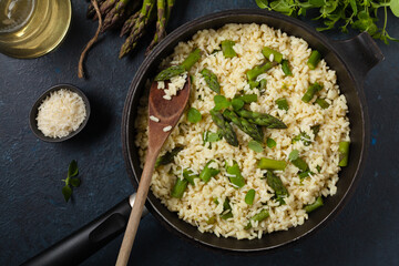 Classic Italian risotto with asparagus. Top view. Darkblue background.