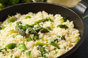Classic Italian risotto with asparagus. Front view. Darkblue background.