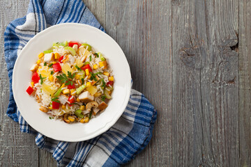 Salad with rice, chicken, peanuts and vegetables. Top view.