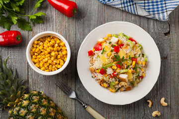 Salad with rice, chicken, peanuts and vegetables. Top view.