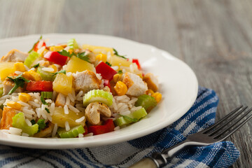 Salad with rice, chicken, peanuts and vegetables. Front view.