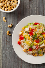 Salad with rice, chicken, peanuts and vegetables. Top view.