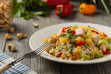 Salad with rice, chicken, peanuts and vegetables. Front view.