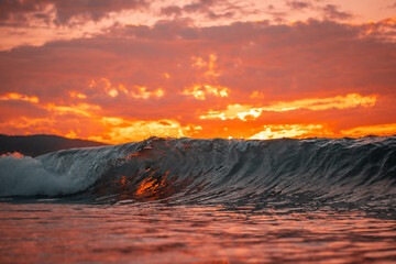 Sunset behind a wave.