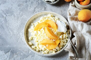 Fresh homemade cottage cheese with sour cream and apricots, breakfast, still life